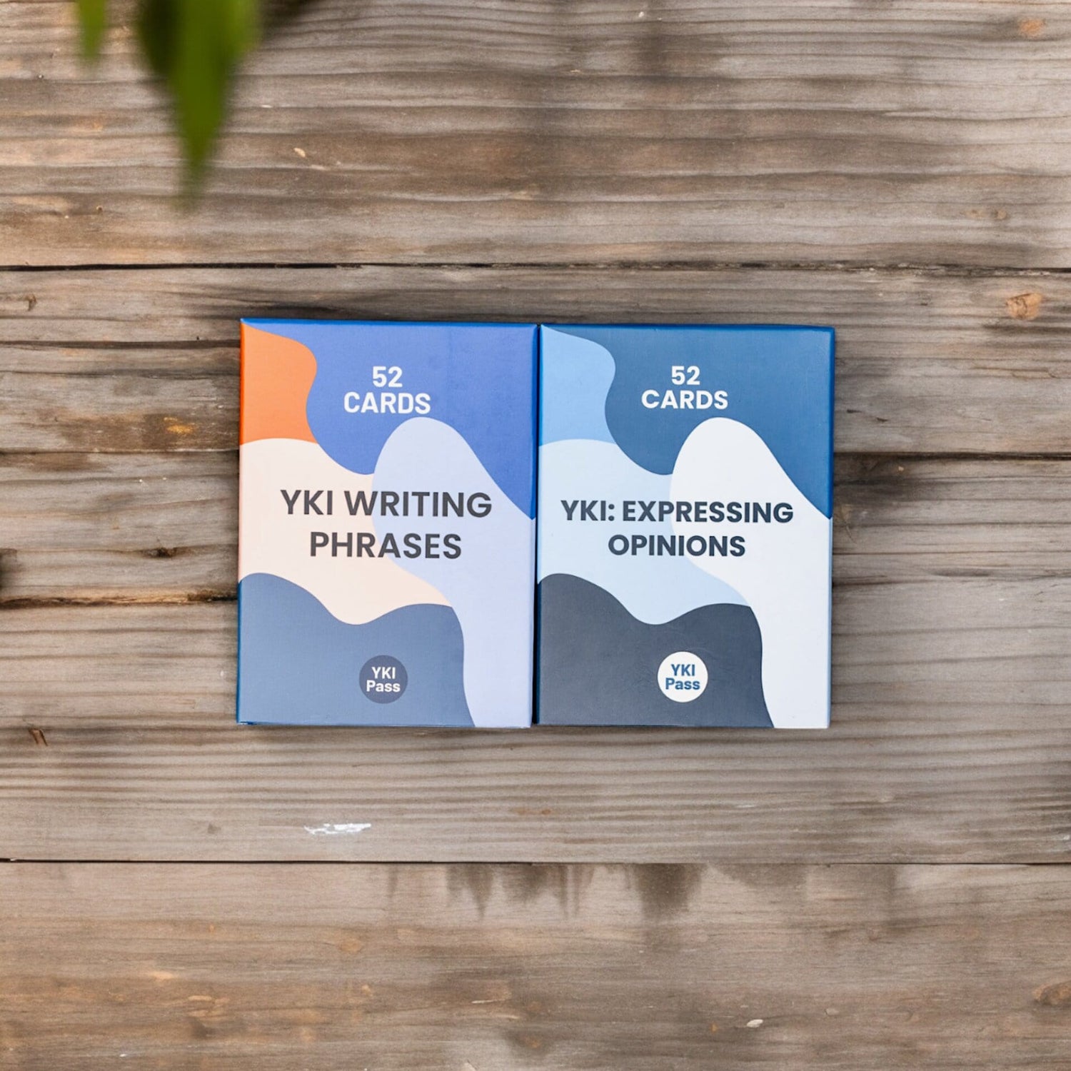 Image of YKI Writing Phrases and YKI Expressing Opinions flashcard boxes together side by side. 