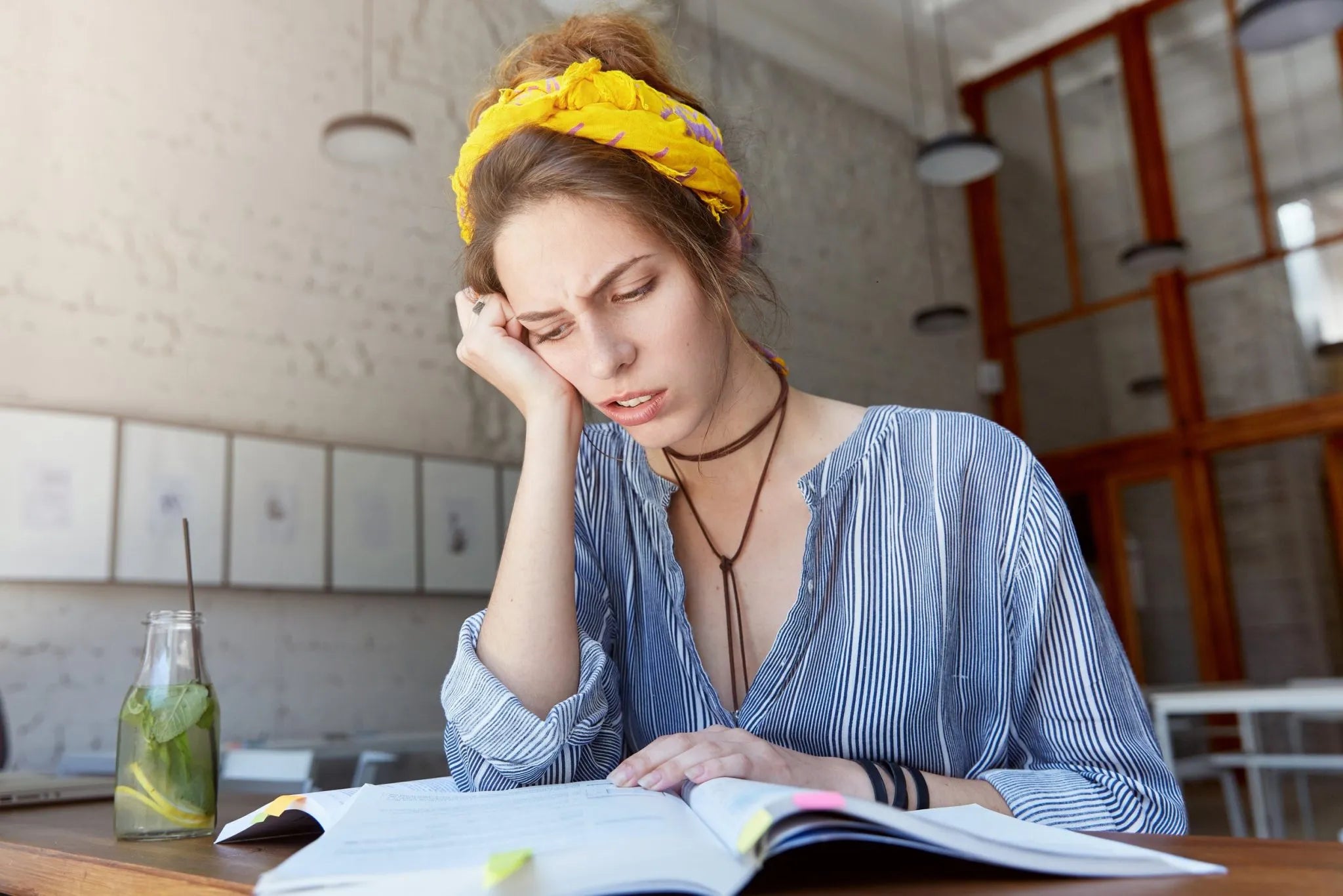 Image of a female person who is preparing for the YKI test but it is not fun to her.